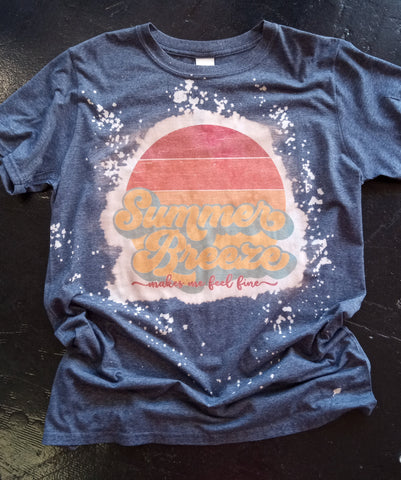 Bleached Blue Shirt with "Summer Breeze Makes Me Feel Fine" Printed on The Front Along with A Sunset