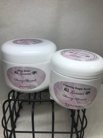 8 ounce bottle of body butter and a 5.75 ounce bottle of foaming sugar scrub both scented cherry almond