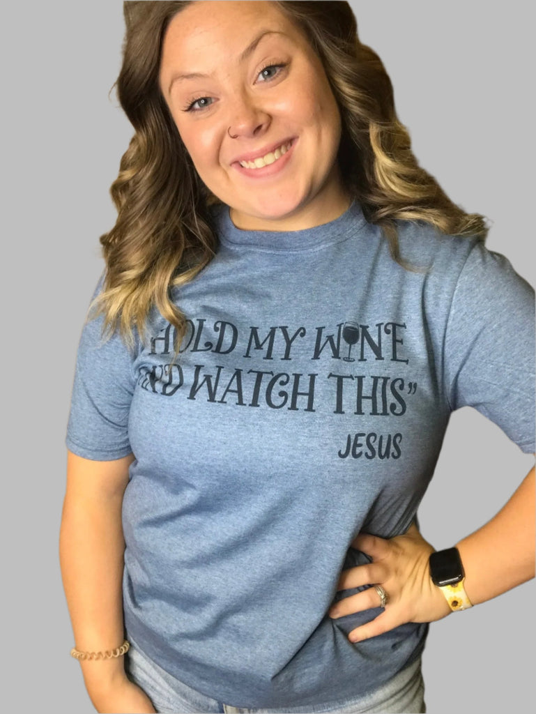 Blue shirt that says "Hold my wine and watch this Jesus" in black lettering