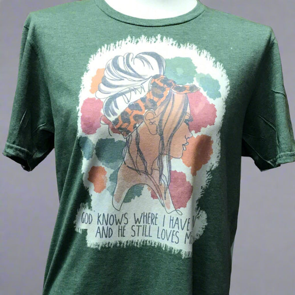 Green short sleeve t shirt with a girl pictured on front. "God knows where I have been and he still love me." written across the bottom.