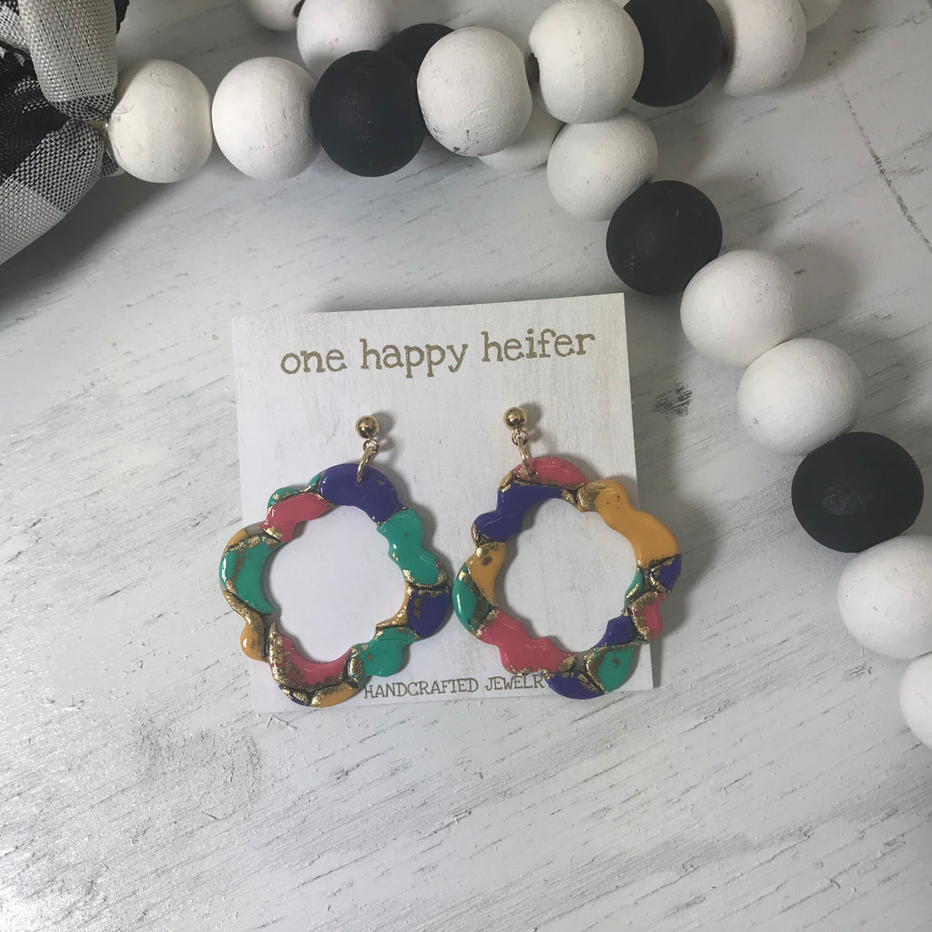 pink, purple, yellow and teal multi colored earrings shaped in a diamond