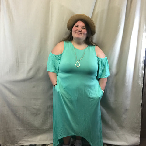 This plus size dress is prefect for the beach or just taking picture! This dress a mint color and it is like a tank but then has the flowing open sleeves also it is a high and low dress. This dress also has pocket on both sides.