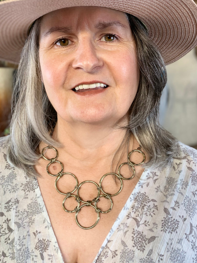 Necklace: Bronze necklace featuring multiple connecting circles.
