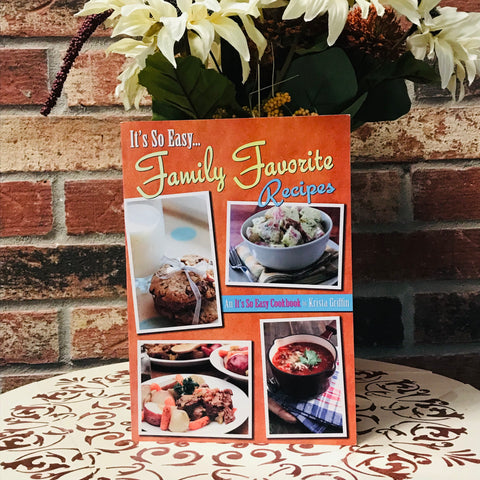Cover of the cookbook “It’s So Easy… Family Favorite Recipes” by Krista Griffin featuring images of homemade cookies, potato salad, hearty beef stew, and a comforting bowl of soup.