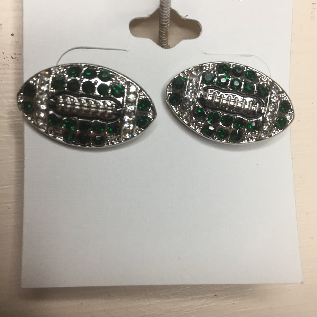 A pair of sparkling green crystal football-shaped earrings with silver-tone detailing, displayed on a white earring card.