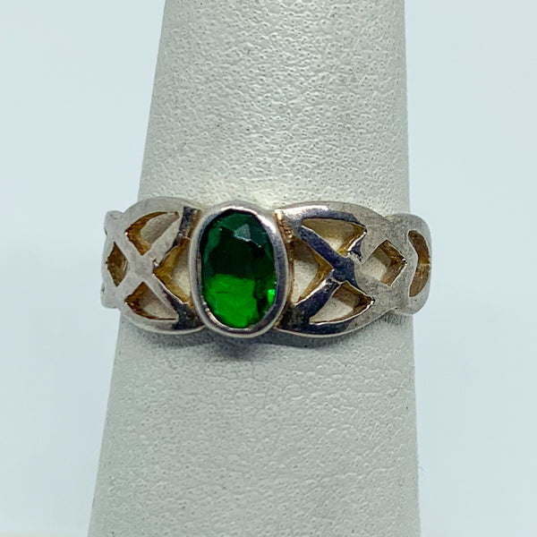 Ring: Sterling silver with an oval green stone, the sides of the ring is in an open braded design. 