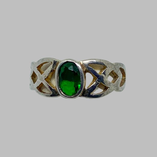 Ring: Sterling silver with an oval green stone, the sides of the ring is in an open braded design.3.5 6/7