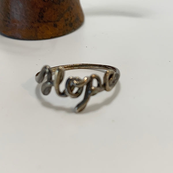 Sterling silver ring with "Hope" written in cursive. 