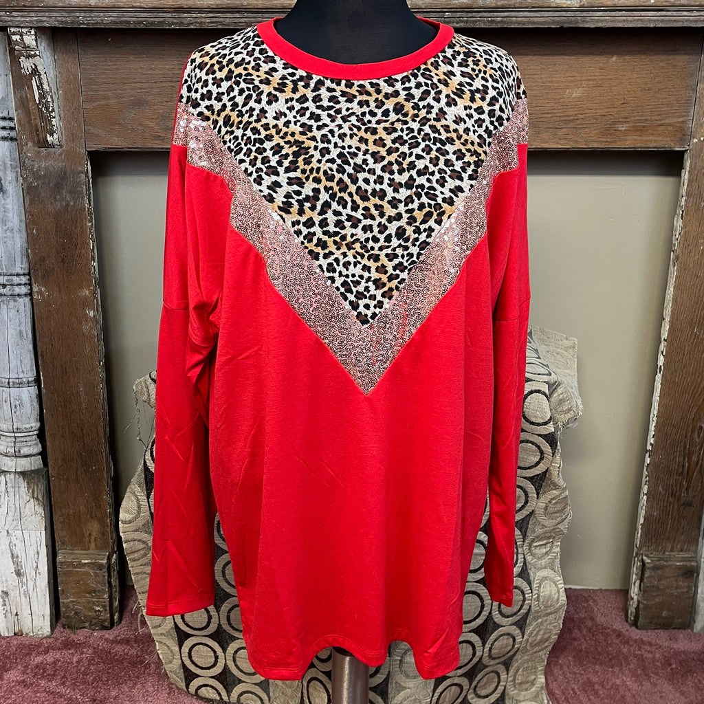 Red Long Sleeve With V neck designed down the front. Bottom V is sequin's with animal print in the middle of V.