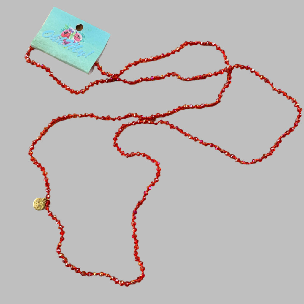 Necklace: Long stand with red faceted beads.