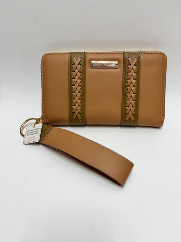 A neutral beige and tan crossbody wristlet with whipstitch accents and gold-tone hardware, photographed on a clean white background