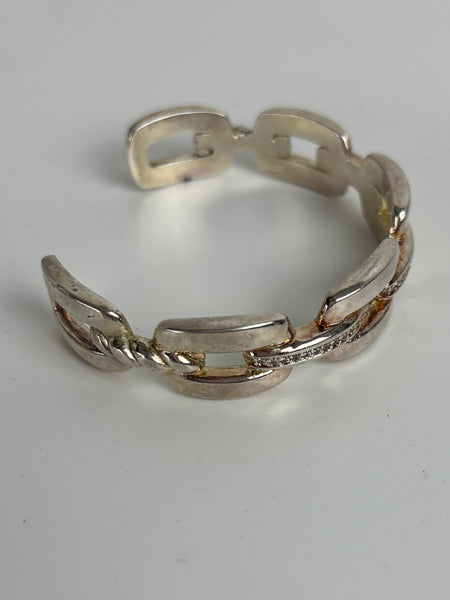 Silver chain-style ring on a light gray background