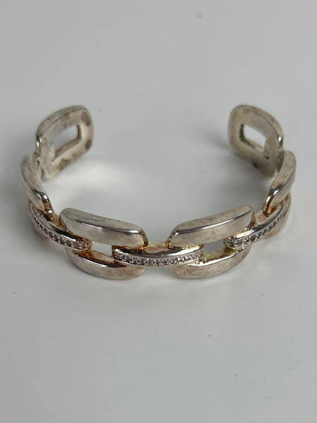 Silver chain-style bracelet on a light gray background
