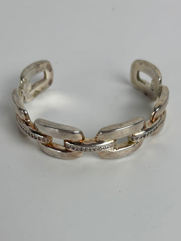 Silver chain-style bracelet on a light gray background