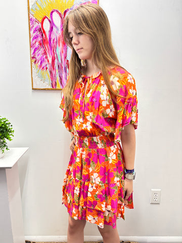 Girl is colorful dress with colorful painting in background