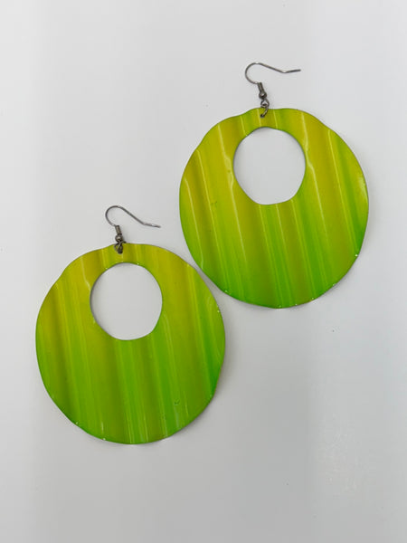 A pair of large circular earrings with an open center, featuring a rippled ombre pattern in shades of yellow, and green