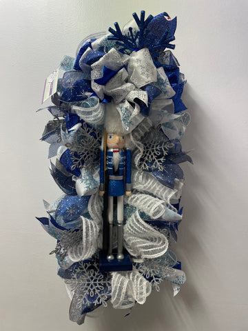25"x13"Nutcracker w/Blue/White/Silver Ribbon Wreath
