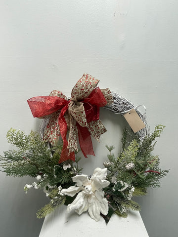 "White Christmas grapevine wreath decorated with elegant white poinsettias, neutral holiday door decor for farmhouse and modern homes"