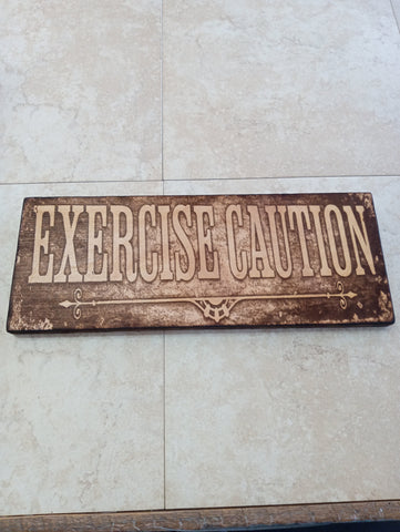 6"x15" wood art lasered "EXERCISE CAUTION" Rick Dantzler