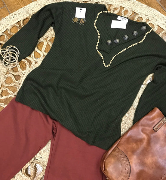 hexagon earrings paired with green waffle shirt and rust flare pants