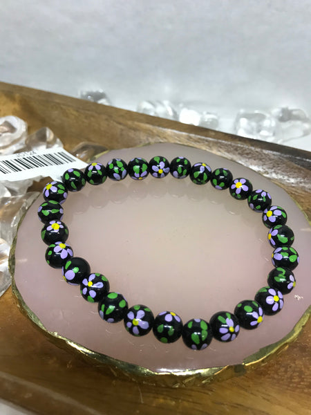 Black Beaded Bracelet with Flower Designs on Each Bead
