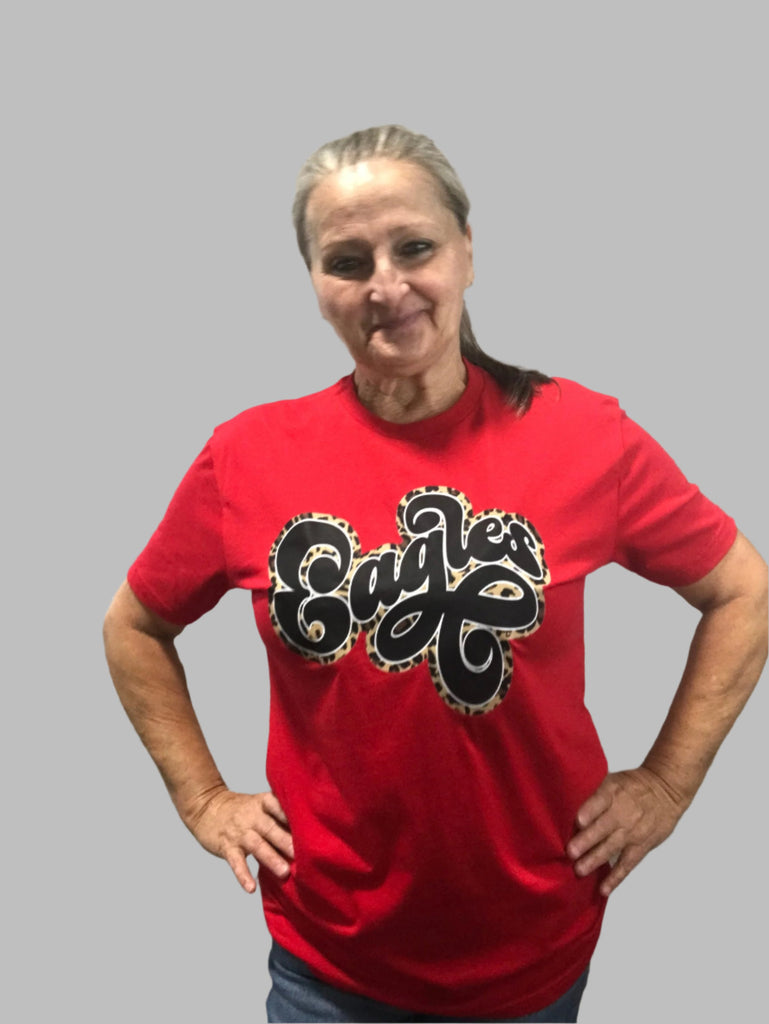 Red t-shirt with "eagles' in a retro font in leopard print.