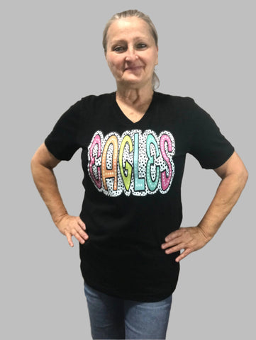 Black V-neck t-shirt with "Eagles" written in different colors on a black and white polka dot back ground.