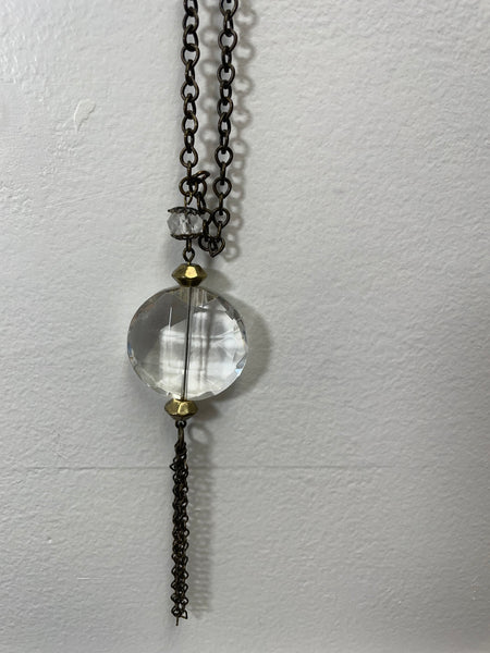 Necklace with a clear crystal pendant on a white background