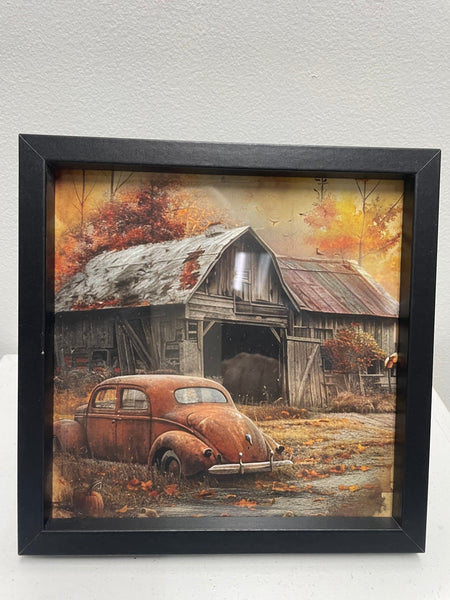 Framed artwork of a rustic scene with an old car and barn in autumn.
