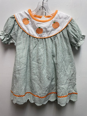 Green checkered dress with orange trim and pumpkin patches 