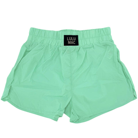 Mint green shorts with ulu Mac logo on white background