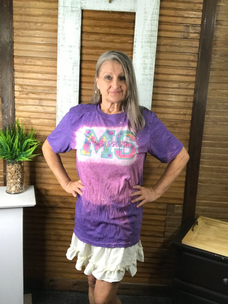 Purple sublimated t-shirt with "MS" in tie dye print then "mississippi" in purple cursive font.