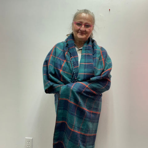 : Plaid ruana with 3-inch fringe tassels. Oversized wrap shawl cape in 100% polyester. Versatile layering piece perfect for fall, winter, and year-round style.