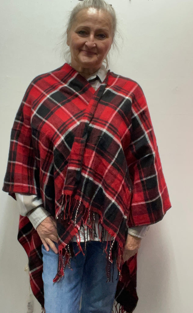 : Plaid ruana with 3-inch fringe tassels. Oversized wrap shawl cape in 100% polyester. Versatile layering piece perfect for fall, winter, and year-round style.