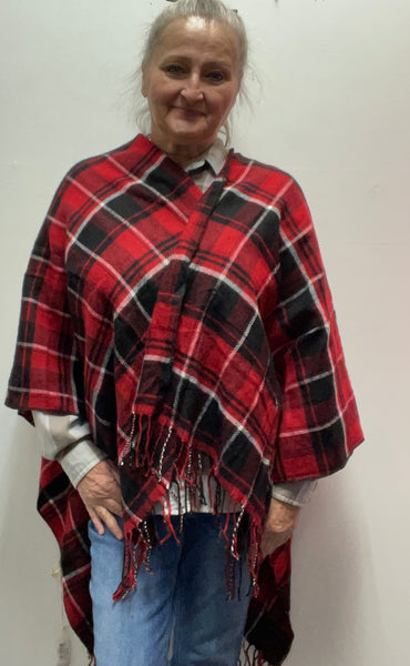 : Plaid ruana with 3-inch fringe tassels. Oversized wrap shawl cape in 100% polyester. Versatile layering piece perfect for fall, winter, and year-round style.