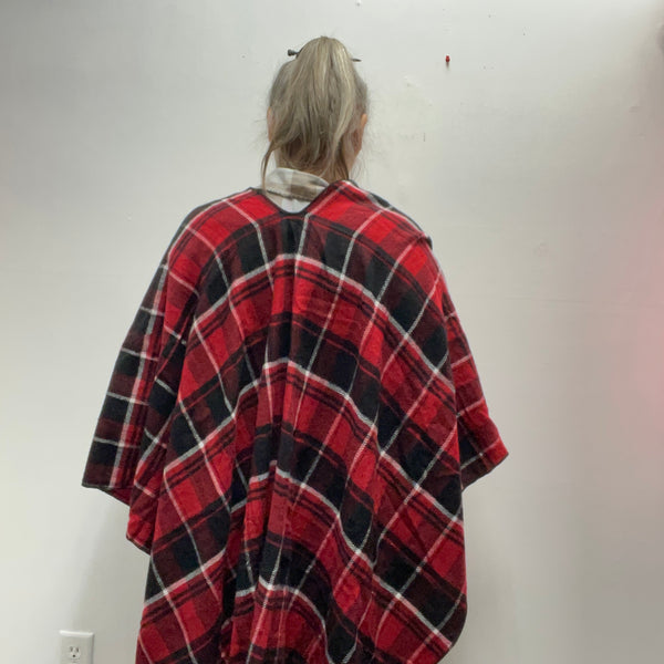 : Plaid ruana with 3-inch fringe tassels. Oversized wrap shawl cape in 100% polyester. Versatile layering piece perfect for fall, winter, and year-round style.