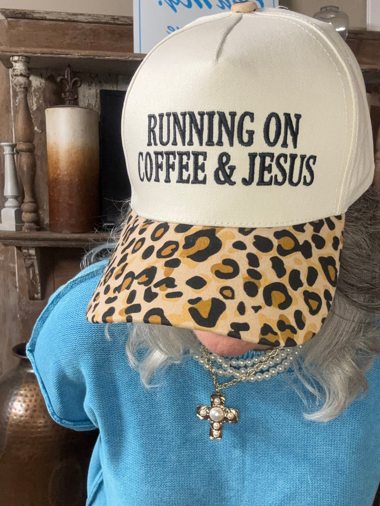 Embroidered Running on Jesus and Coffee Ball Cap with Leopard bill on woman with blue shirt and decorated background
