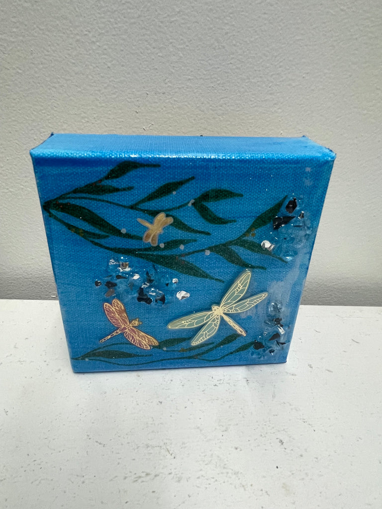 Three-dimensional resin dragonfly mounted on wrapped canvas wall art by Tiffany Sutton featuring detailed wings and natural design-blue