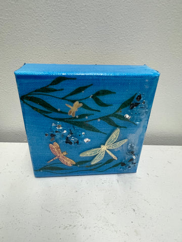 Three-dimensional resin dragonfly mounted on wrapped canvas wall art by Tiffany Sutton featuring detailed wings and natural design-blue