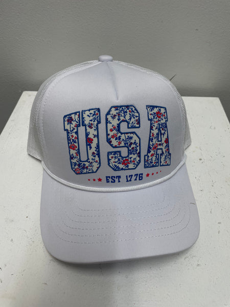 White cap with floral lettering