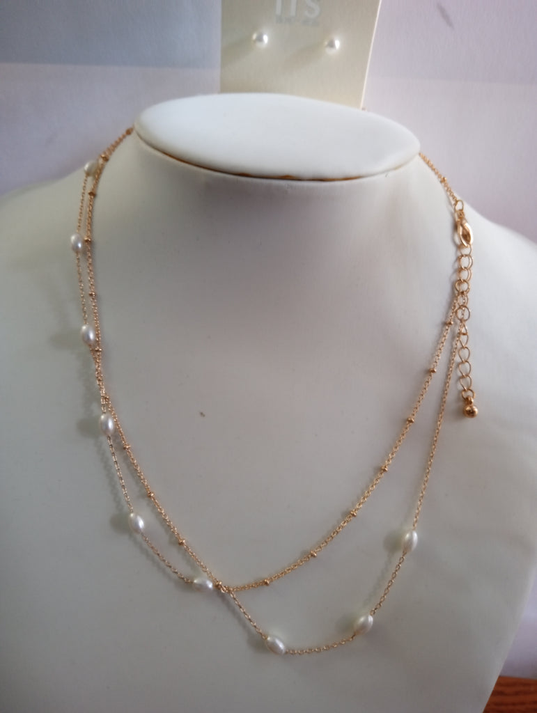A double-layered necklace with a fine gold chain and small white pearls w/faux pearl earrings studs