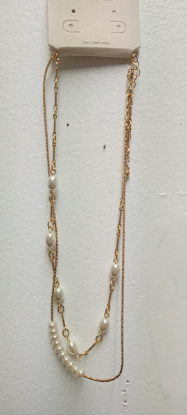 A double-strand gold chain necklace with white freshwater pearls