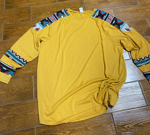 Long sleeve shirt in yellow with aztec sleeves.