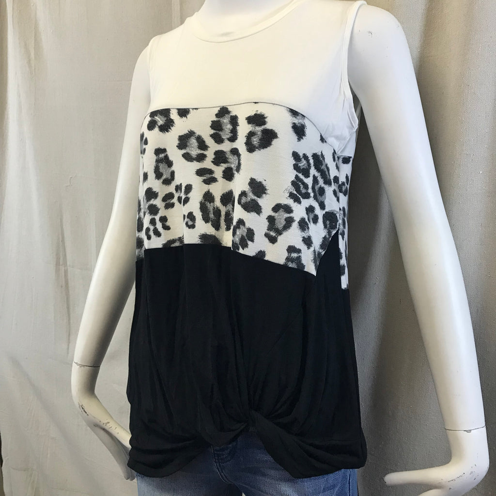 This tank has three different patterns on the shirt. It starts at the with just a white color then the middle is leopard print pattern and lasty the bottom is a black color with a twist hem.