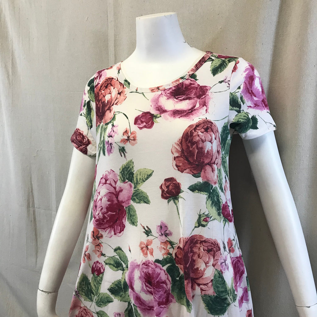 This dress is an ivory color with floral pattern all over it also with pocket on both sides.