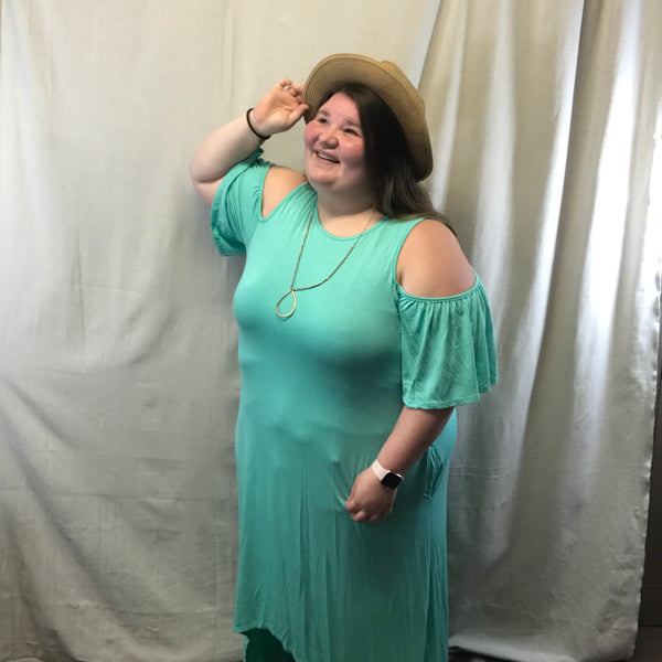 This dress a mint color and it is like a tank but then has the flowing open sleeves. This dress also has pocket on both sides.