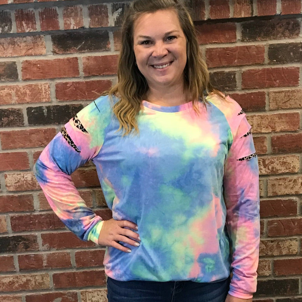 Blue, pink, and yellow tie-dye sweater with cut outs on sleeve with leopard print