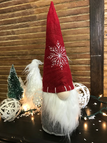 Christmas Gnome with a long white beard and a big red hat with a white snowflake on it