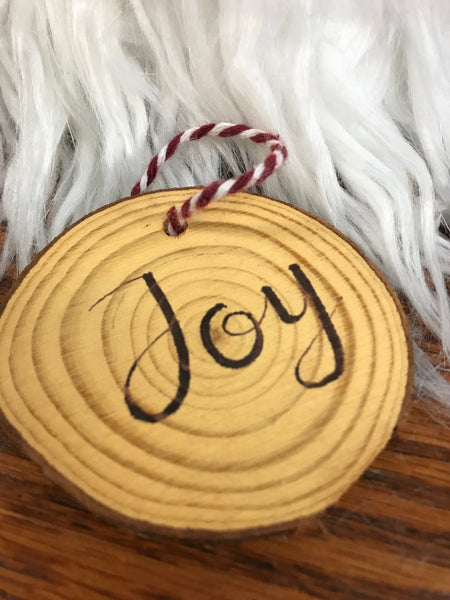 wood ornament with joy burned into it