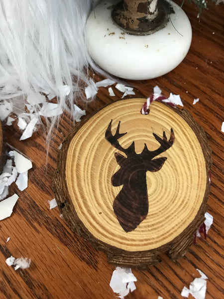 wood ornament with a deer burned into it